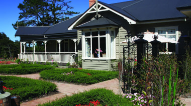 Enchanting Villa - Corrugate Iron Sand - Exterior cottage, estate, farm, farmhouse, flower, garden, grass, home, house, landscape, landscaping, lawn, plant, real estate, residential area, sky, spring, suburb, tree, wildflower, yard, blue