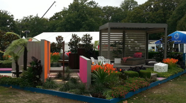 The Louvretec stand at the Ellerslie Flower Show backyard, canopy, garden, house, outdoor structure, plant, real estate, recreation, roof, shed, tree, yard, brown