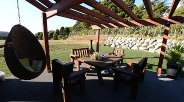 A patio with timber based decor at a furniture, outdoor structure, property, table, black