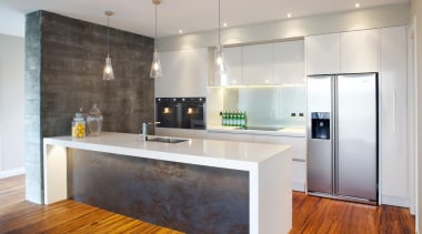 This industrial style kitchen makes use of a cabinetry, countertop, floor, flooring, interior design, kitchen, real estate, room, wood flooring, gray