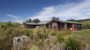 View of exterior from a distance - Exterior cottage, estate, home, house, land lot, landscape, plant community, property, real estate, shrubland, sky, brown