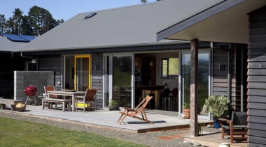 View of exterior with patio and yellow window cottage, home, house, outdoor structure, porch, property, real estate, siding, window, gray, black