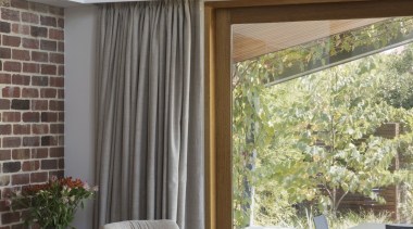 A dark cork floor complements the white walls architecture, ceiling, curtain, furniture, home, house, interior design, living room, shade, table, window, window covering, window treatment, wood, gray