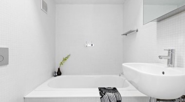 A large bathtub dominates the bathroom - A architecture, bathroom, bathroom sink, bidet, black and white, floor, house, interior design, plumbing fixture, product design, property, room, tap, tile, wall, white