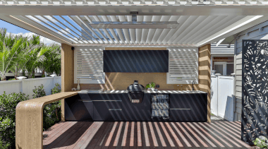The outdoor kitchen boasts a dual operation louvre 