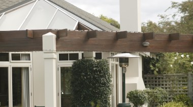 Outdoor living area in Wanaka - Landmark Wanaka home, house, outdoor structure, property, real estate, residential area, roof, white, brown