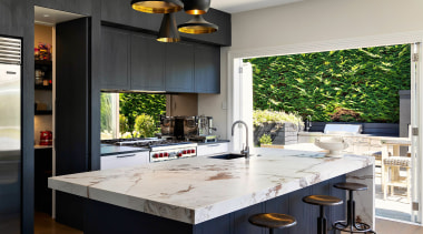 The waterfall-end Florim benchtop has the chunky, veined 