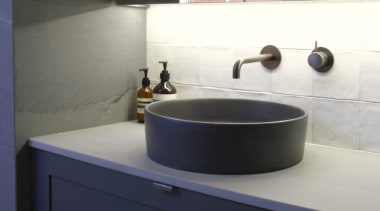 Small, hand-made tactile tiles add a soft textural 