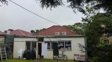 The Victorian home before receiving love and attention. architecture, backyard, building, cottage, estate, home, house, neighbourhood, property, real estate, residential area, roof, rural area, sky, tree, yard, white