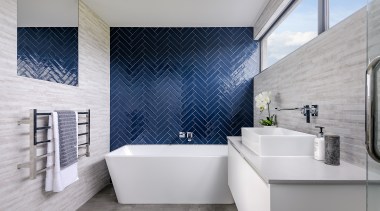 A bold feature wall of blue herringbone tiles 