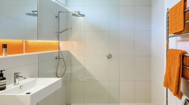 A brilliant strip of orange mosaic tiles add 