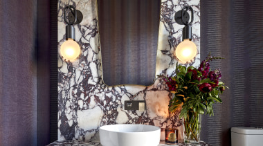 Vibrantly veined stone slabs and striking vinyl-faced wallpaper 