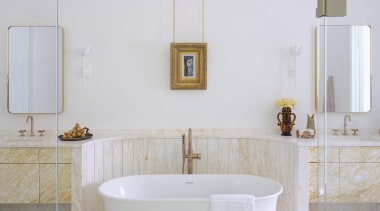This bathroom's walls are finished in hand-applied plaster, 