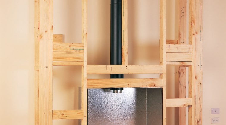 Wooden framing for installing a gas fireplace against bookcase, cabinetry, cupboard, floor, furniture, hardwood, shelf, shelving, wall, wardrobe, wood, wood stain, orange