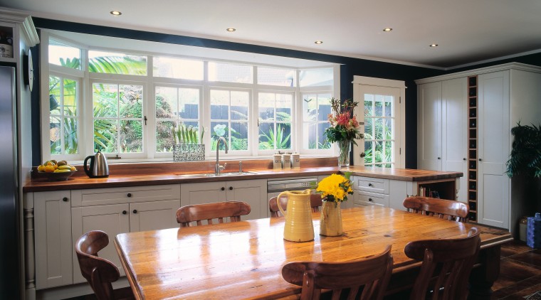 The view of a traditional styled kitchen - countertop, dining room, interior design, kitchen, property, real estate, room, table, window, gray, black