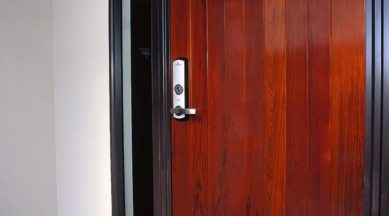 A photograph of a wooden door with a door, wardrobe, wood, wood stain, red, gray
