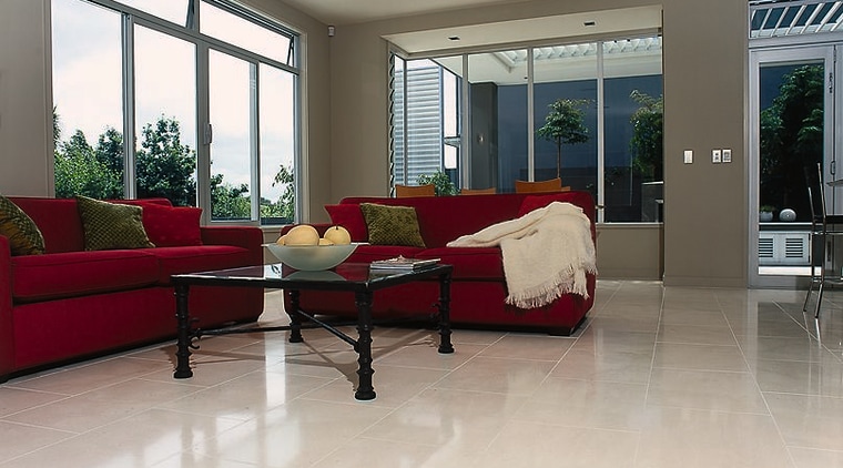 A lounge area with red sofas, red and floor, flooring, hardwood, home, house, interior design, laminate flooring, living room, property, real estate, room, window, wood, wood flooring, gray, white