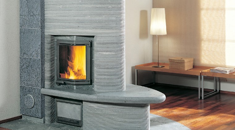 A photograph of a curved fireplace. The area fireplace, floor, flooring, hearth, heat, home appliance, wood burning stove, gray