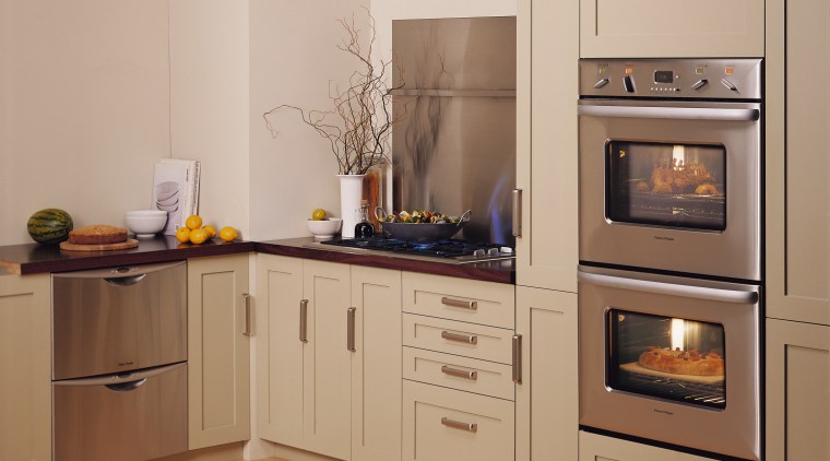 A kitchen featuring two Fisher &amp; Paykel ovens. cabinetry, countertop, cuisine classique, home appliance, kitchen, kitchen appliance, kitchen stove, major appliance, oven, refrigerator, room, orange, brown