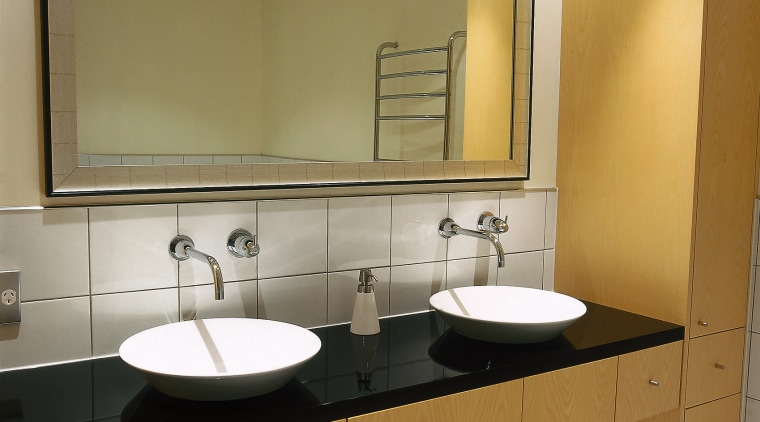 A bathroom featuring a large mirror, basins, taps bathroom, bathroom accessory, bathroom cabinet, countertop, interior design, plumbing fixture, product design, room, sink, brown
