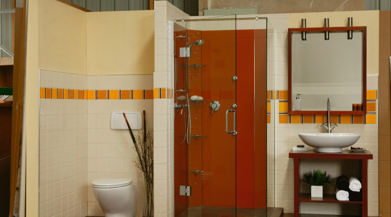 A bathroom featuring an orange coloured glass shower. bathroom, bathroom accessory, floor, interior design, plumbing fixture, room, toilet, brown, orange