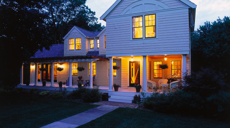 View of the home in evening, showing lighting, architecture, building, cottage, estate, evening, facade, farmhouse, home, house, lighting, mansion, property, real estate, residential area, siding, sky, suburb, window, black