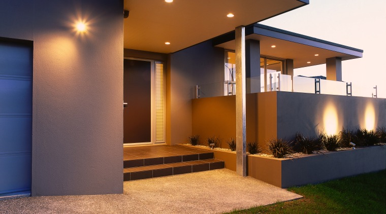 View of the front entrance of this modern architecture, elevation, estate, facade, home, house, interior design, lighting, property, real estate, residential area, siding, window, brown