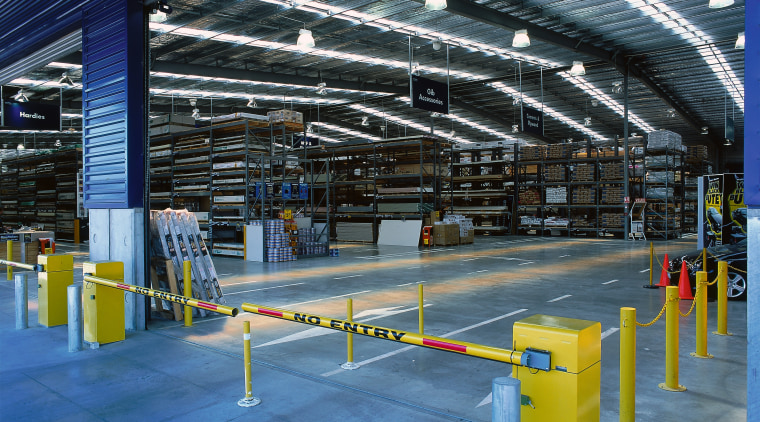 Interior of large Placemakers store with extensive concrete airport terminal, factory, structure, blue