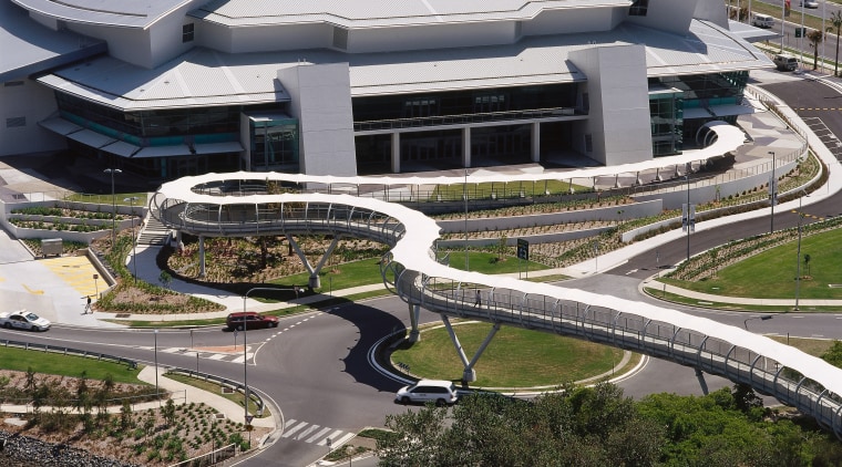 Long snaking pedestrian bridge with white canopy overhead, aerial photography, architecture, bird's eye view, building, city, fixed link, metropolitan area, structure, urban area, urban design, water, black, gray