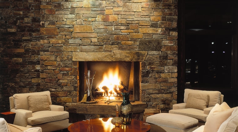 View of the living area, stone fireplace, stone ceiling, fireplace, hearth, home, interior design, lighting, living room, lobby, wall, wood burning stove, black, brown