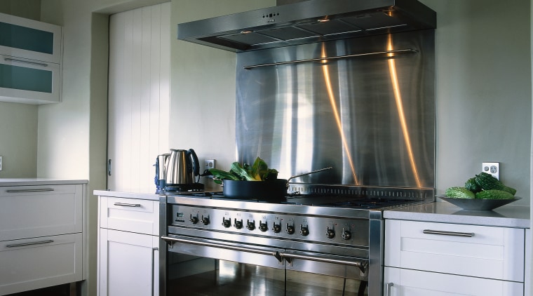 Kitchen with white cabinetry, timber flooring and large cabinetry, countertop, cuisine classique, gas stove, home appliance, interior design, kitchen, kitchen appliance, kitchen stove, major appliance, refrigerator, gray, black