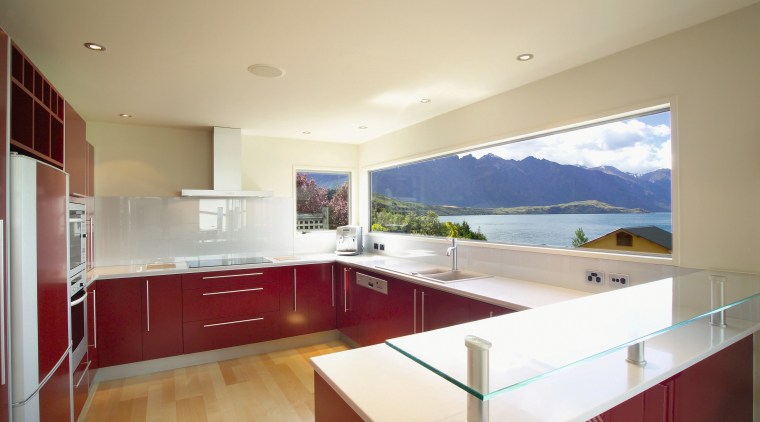 Kitchen with deep red cabinetry and silver toned apartment, architecture, ceiling, countertop, daylighting, estate, floor, home, house, interior design, kitchen, property, real estate, room, window, orange