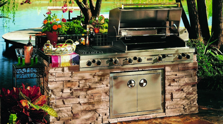 Outdoor barbeque set into stone wall base. - backyard, barbecue, barbecue grill, outdoor grill, black