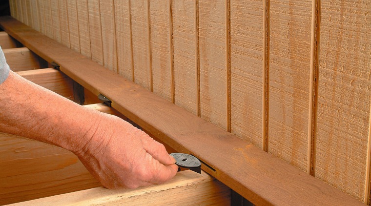 Close up view of the fastening system on floor, flooring, hardwood, line, lumber, material, plywood, wall, wood, wood stain, orange, brown