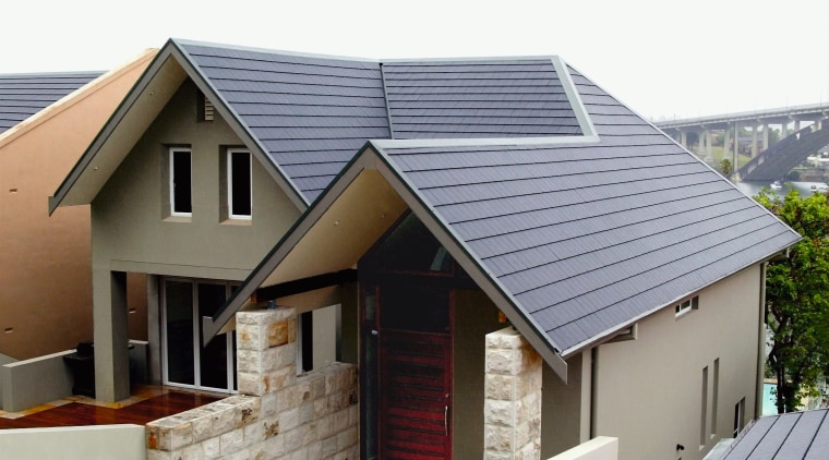 Exterior view of front of house with tan daylighting, facade, home, house, property, real estate, roof, siding, gray