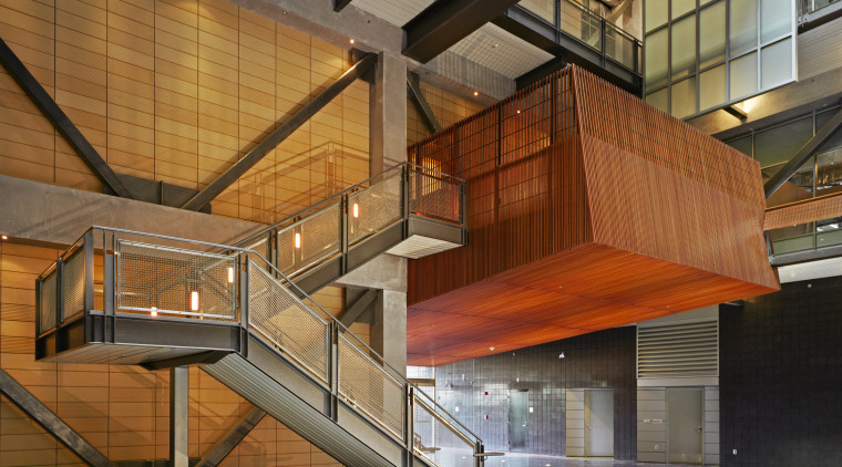 A view of the large metal rusty coloured architecture, building, daylighting, facade, stairs, wood, brown