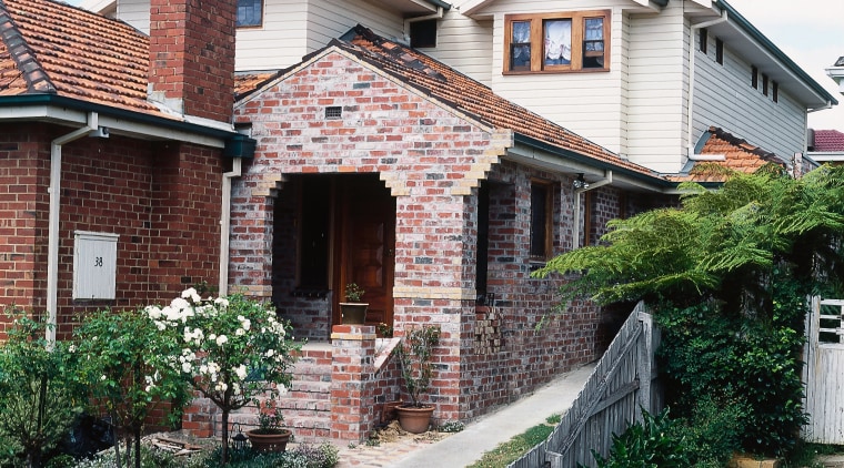 Exterior of home with brick cladding in front building, cottage, estate, facade, home, house, neighbourhood, property, real estate, residential area, roof, siding, suburb, villa, window, white