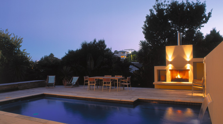 view of the outdoor entertainment area and mayfair backyard, estate, evening, home, house, lighting, property, real estate, reflection, residential area, roof, sky, swimming pool, villa, water, blue