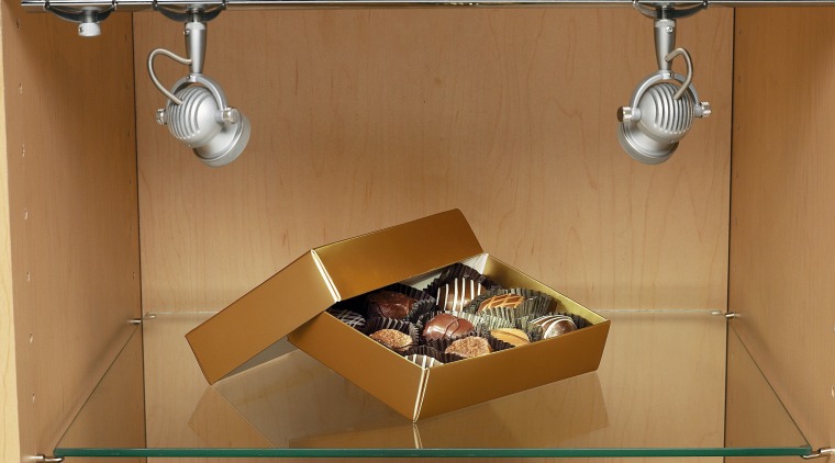 View of a choclate box on a gass furniture, product, product design, shelf, table, brown, orange