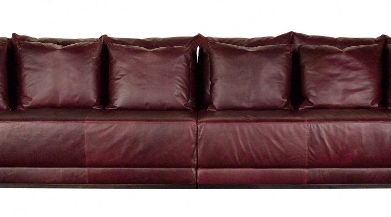 View of a very long, square brown leather couch, furniture, loveseat, sofa bed, red, white