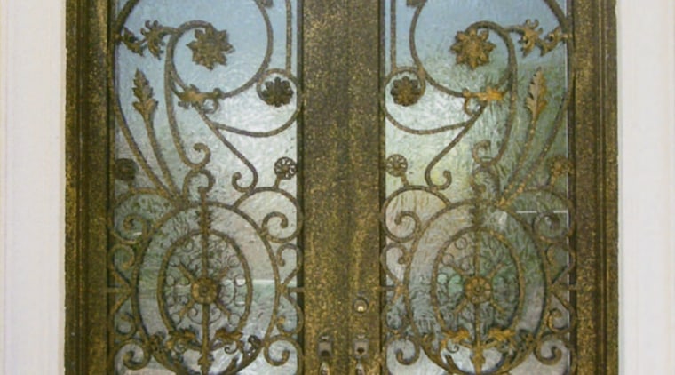 Close up view of a wooden door with door, glass, iron, metal, brown, gray