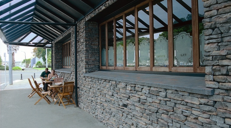 Exterior view of building with stone cladding, timber house, outdoor structure, porch, real estate, window, gray, black