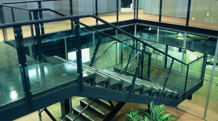 A view of a large metal and galss glass, leisure centre, teal