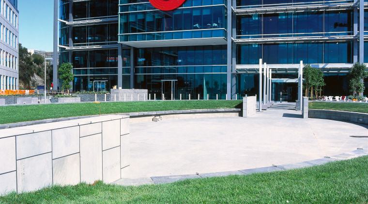 View of front of Vodafone building with grass architecture, building, city, condominium, corporate headquarters, daytime, facade, grass, headquarters, neighbourhood, real estate, residential area, sky, urban area, white