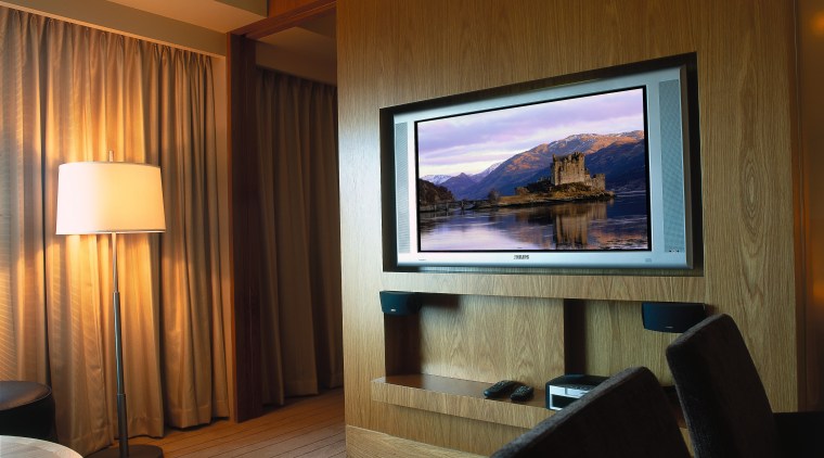 Hotel room with wall mounted plasma tv. - ceiling, display device, entertainment, interior design, living room, real estate, room, suite, wall, brown