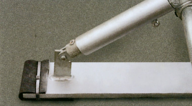 Closeup of collapsible guard rail system, in folded gray