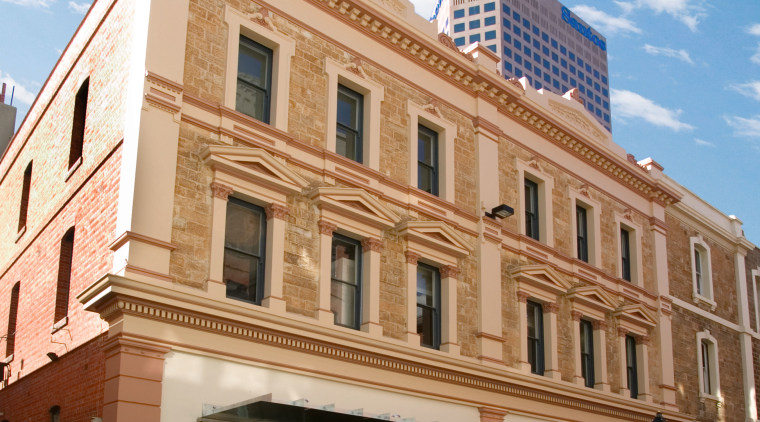 view of this adelaide heritage protected building that apartment, architecture, building, city, commercial building, condominium, daytime, downtown, facade, house, landmark, metropolis, metropolitan area, mixed use, neighbourhood, property, real estate, residential area, sky, town, window, white