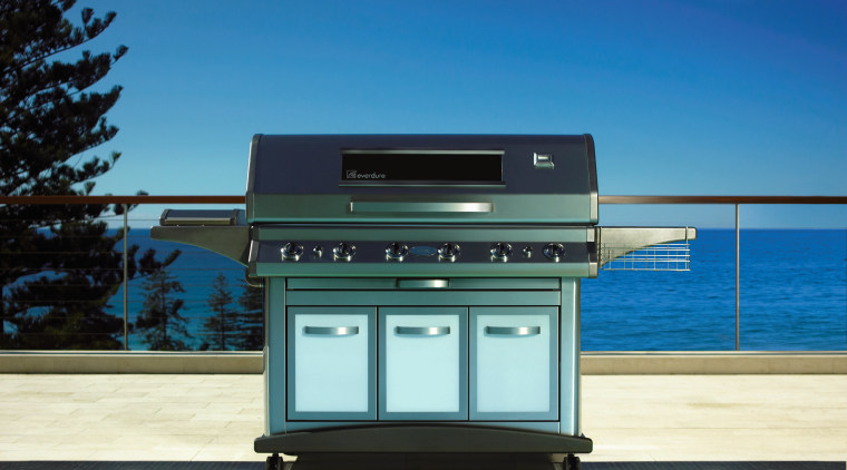 A view of a large steel BBQ in daylighting, teal, blue