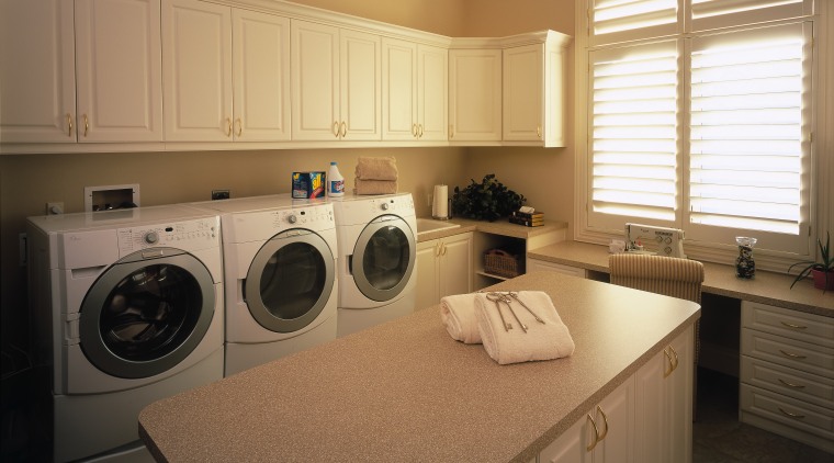 A view of the laundry ara, many white cabinetry, clothes dryer, countertop, home, home appliance, kitchen, laundry, laundry room, major appliance, room, washing machine, brown, orange