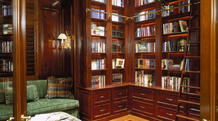 view of the study with a stained dark bookcase, flooring, furniture, institution, interior design, library, lobby, public library, shelving, red